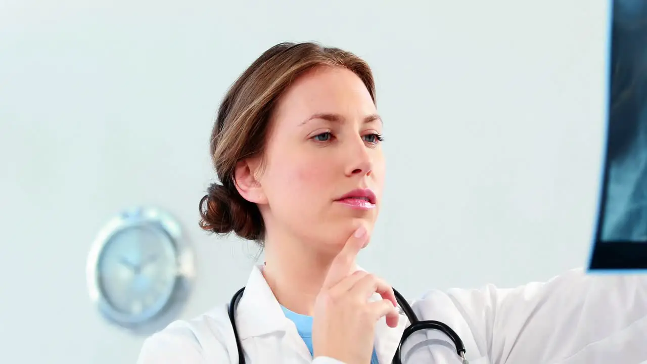 Female doctor examining a x-ray report