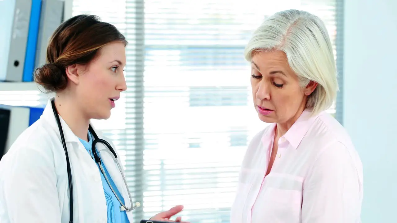 Female doctor interacting over a report on digital tablet with a patient