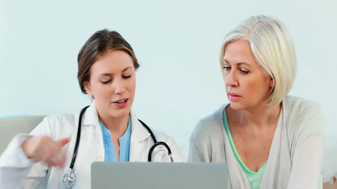 Female doctor interacting over a x-ray report with a patient