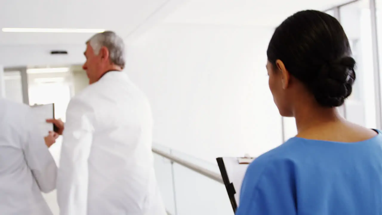 Doctors and nurse running in passageway of hospital