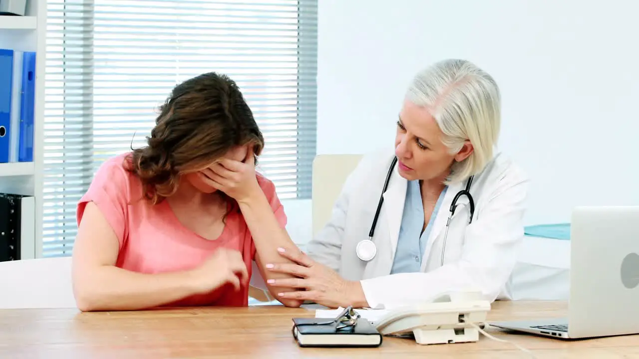 Female doctor consoling a patient