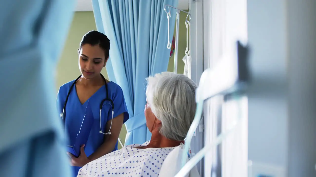 Senior patient being checked by female doctor in the ward