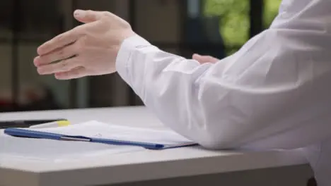 Sliding Shot of Medical Professionals Hands Gesturing as He Talks