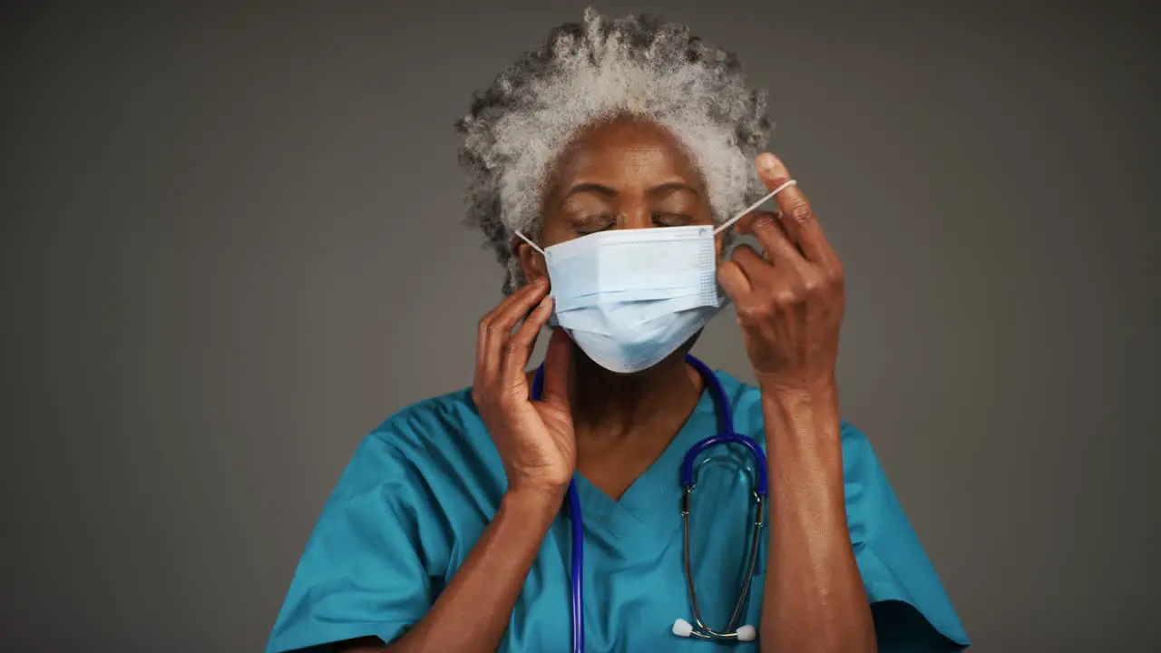 Middle Aged Doctor Removing Face Mask and Smiling Portrait