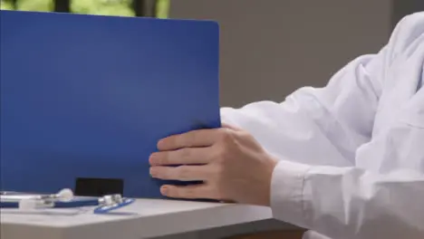 Tracking Shot Orbiting Medical Professional Working at His Desk