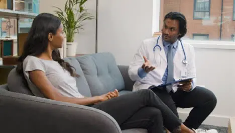 Young Woman Having Chat with Doctor