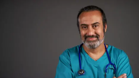 Middle Aged Doctor Folding Arms and Smiling Portrait