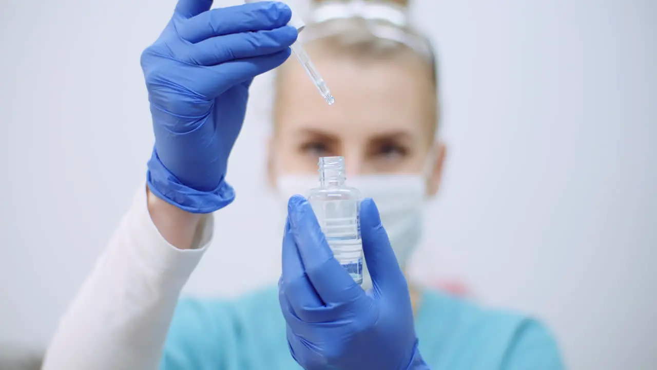 Female Scientist Using Pipette Analyzes A Liquid 1