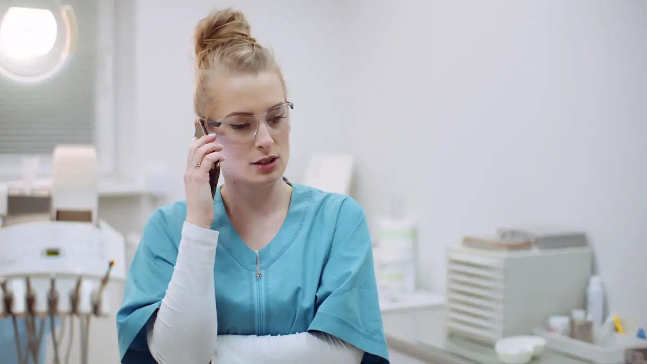 Female Doctor Talking On Mobile Phone At Healthcare Clinic 3