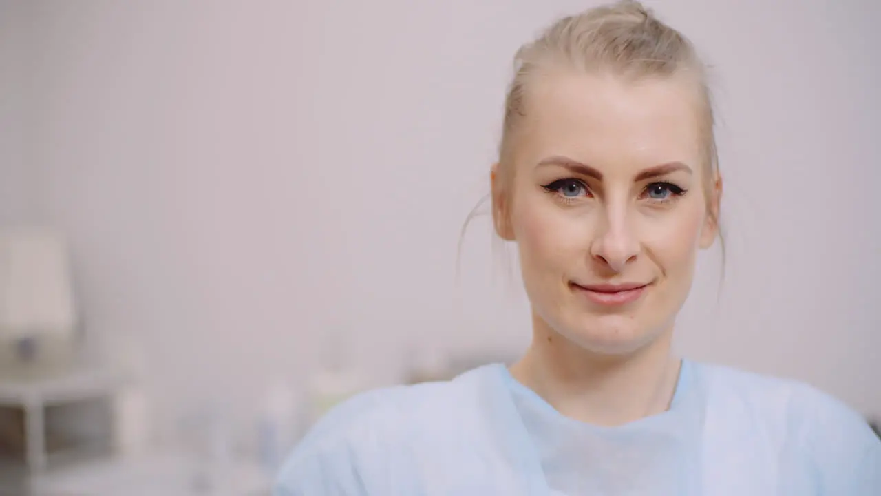 Extreme Close Up Of Female Doctor Smiling And Drinking Glass Of Water