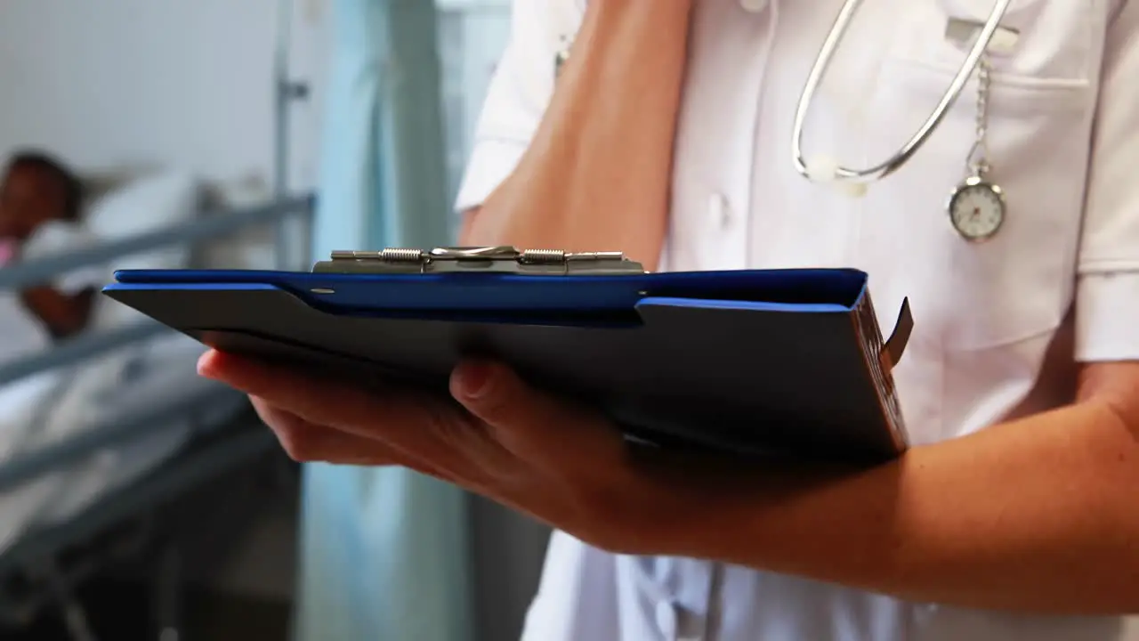 Female doctor writing on a clipboard