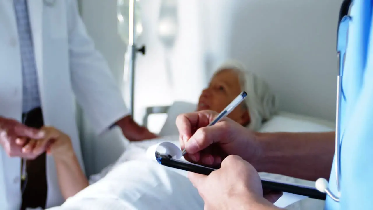 Nurse writing on the clipboard in the hospital