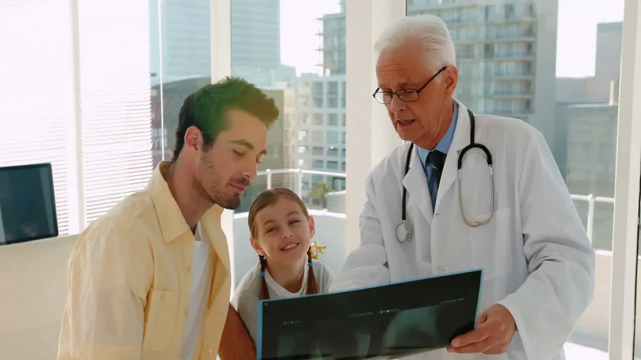 Doctor showing x-ray report to male patient