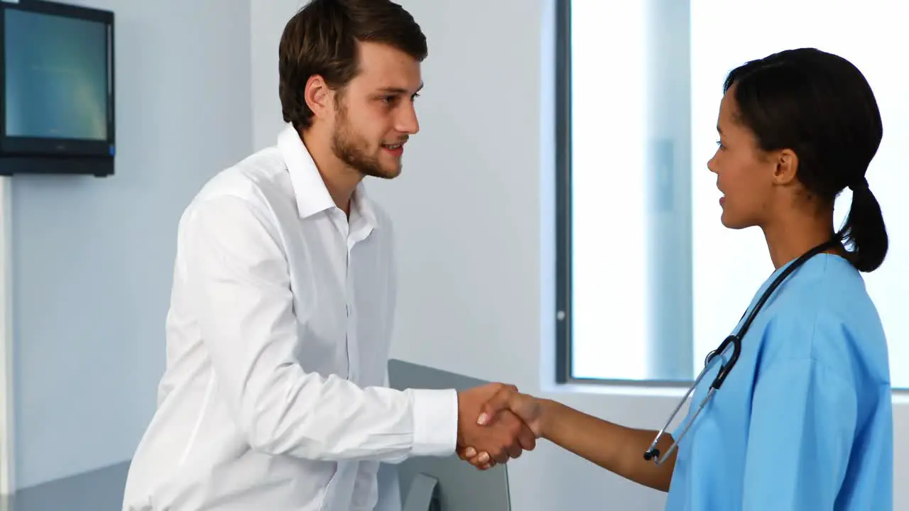 Doctor and patient shaking hands in clinic