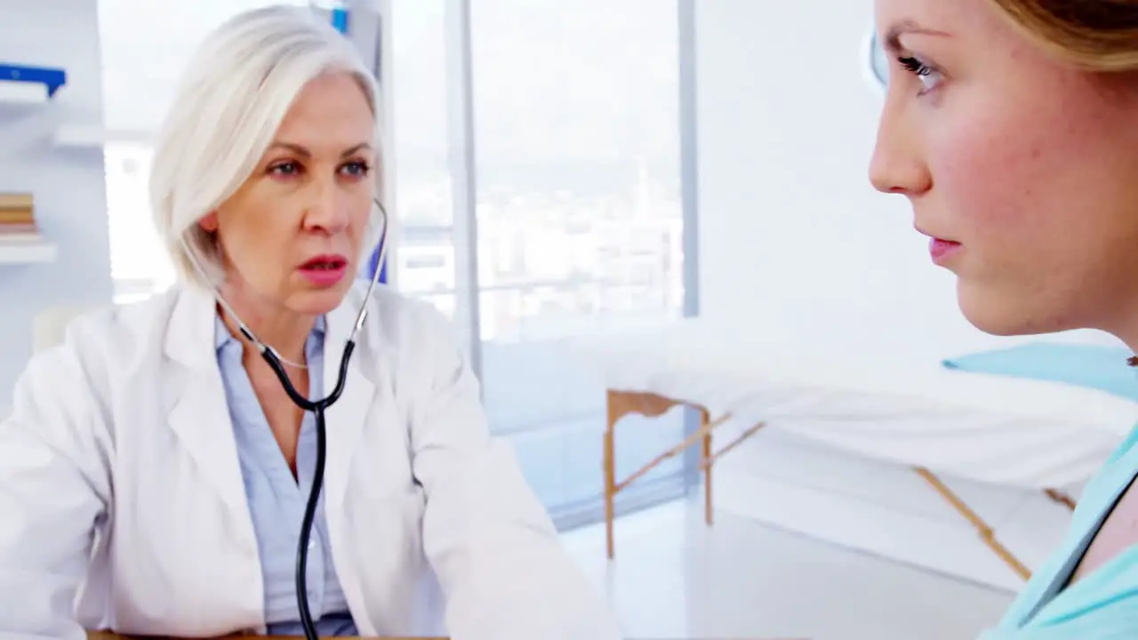 Female doctor checking blood pressure of patient