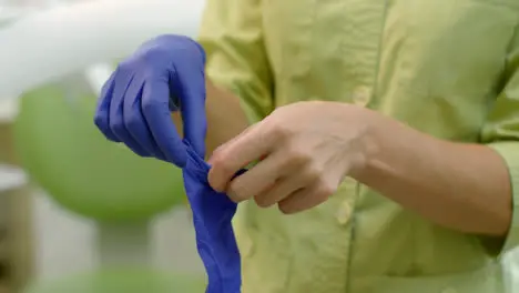 Female doctor hands putting on sterile gloves Laboratory worker hands