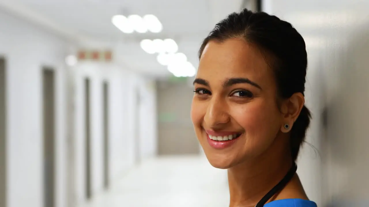 Portrait of female doctor standing in corridor