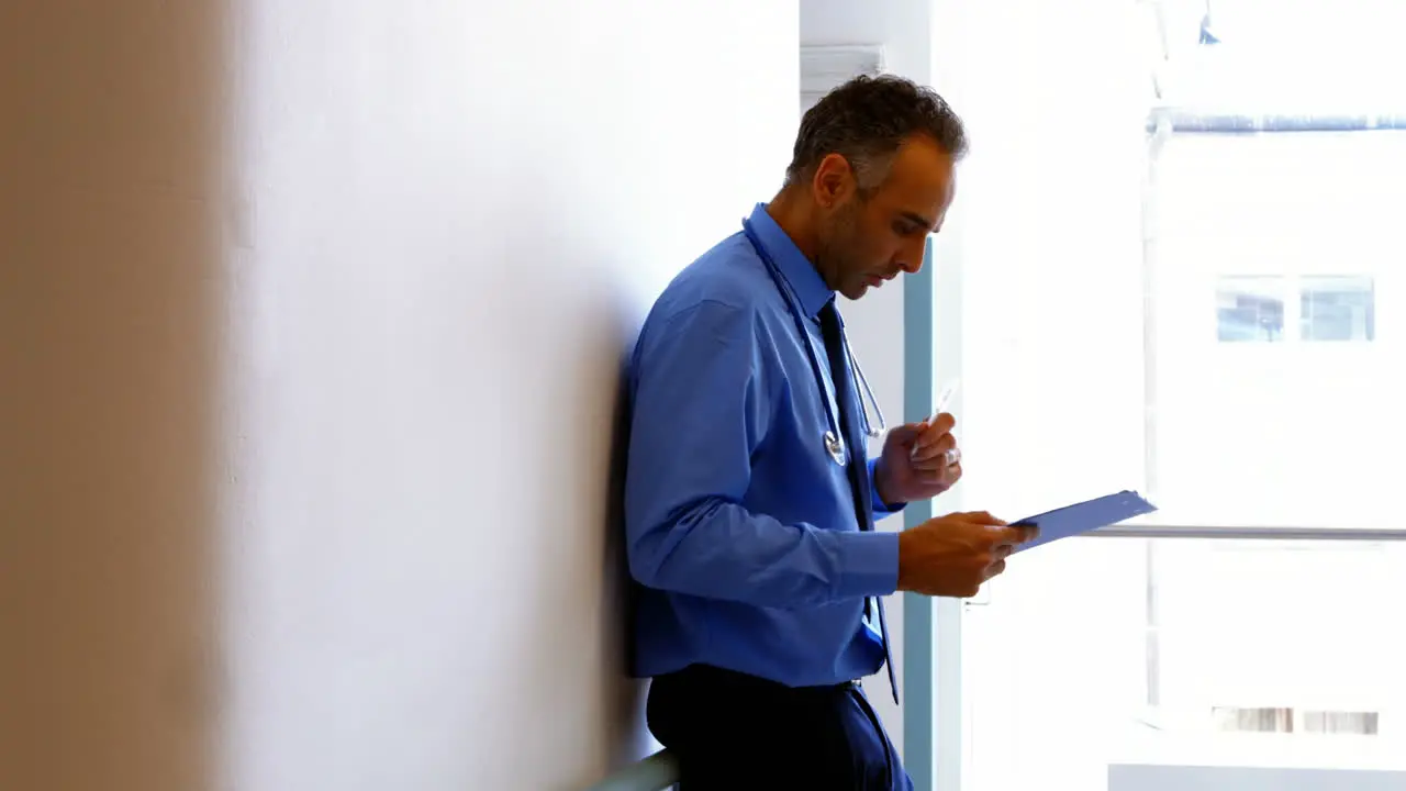 Doctor writing on clipboard