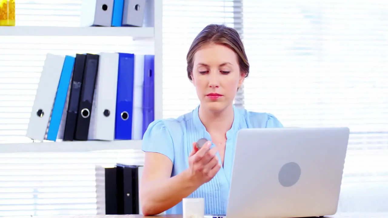 Female doctor working over laptop at her desk