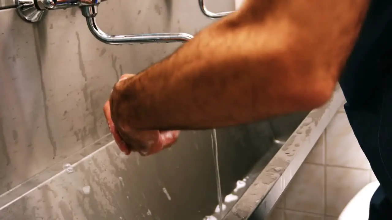 Male surgeon washing his hands