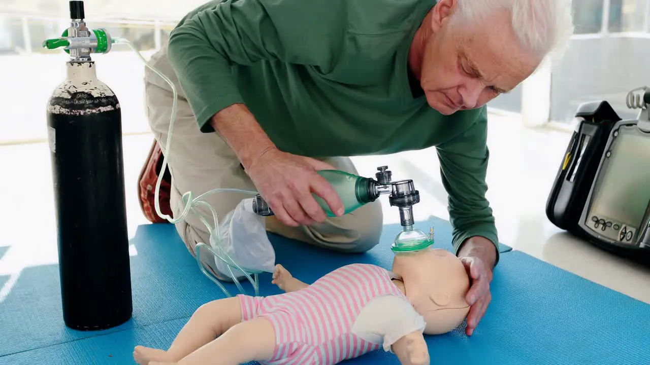 Male paramedic giving oxygen to a dummy