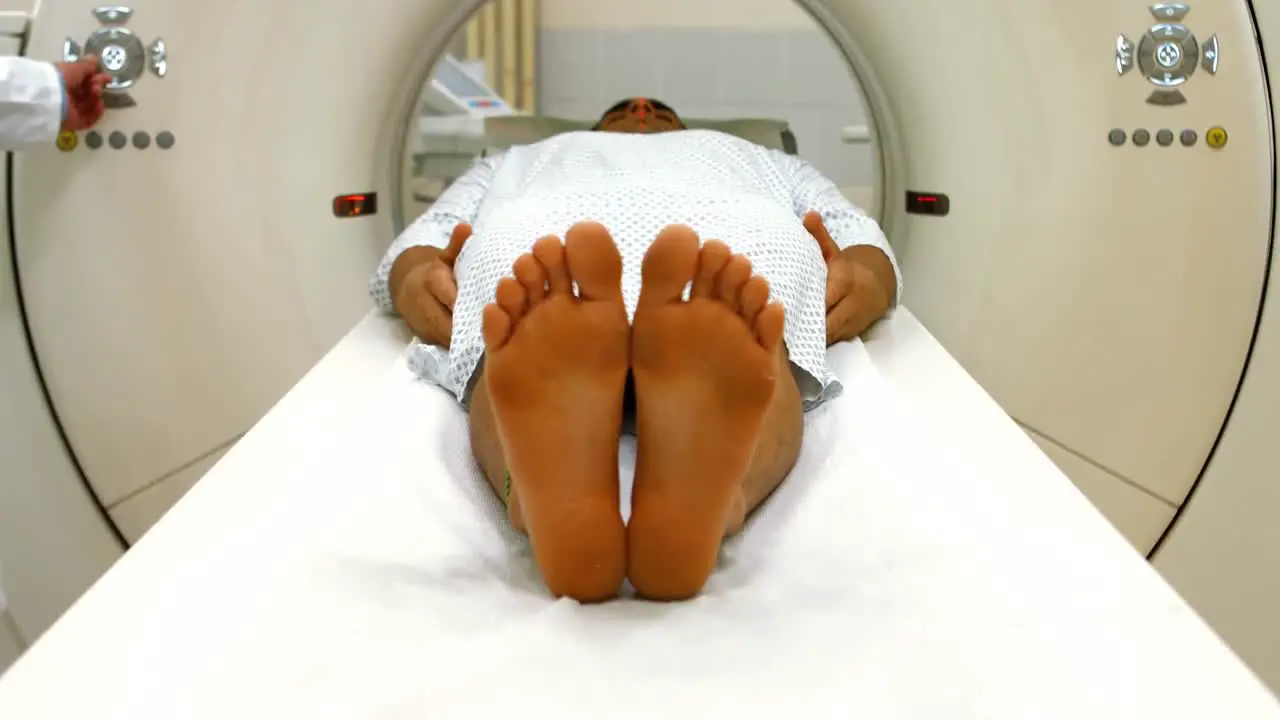 A male patient lying on an mri machine