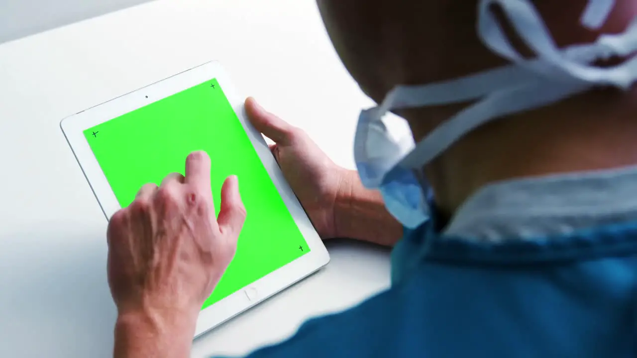 Female doctor using over digital tablet