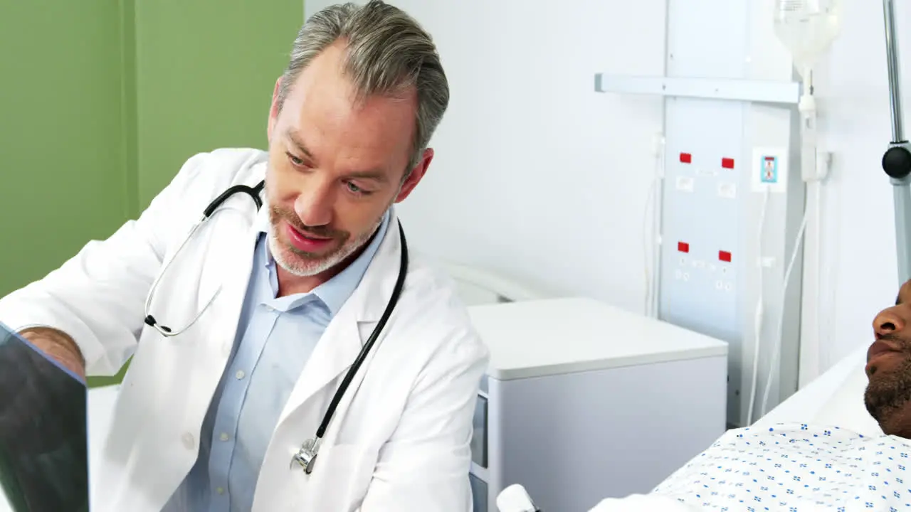 Male doctor discussing x-ray with patient