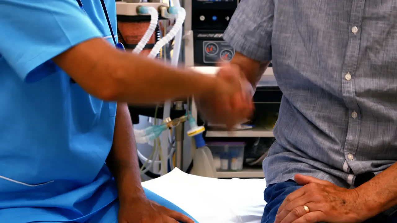 Female doctor shaking hands with patient