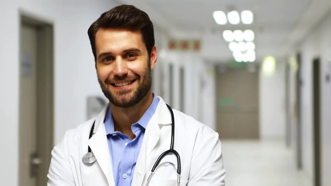 Portrait of smiling male doctor in corridor