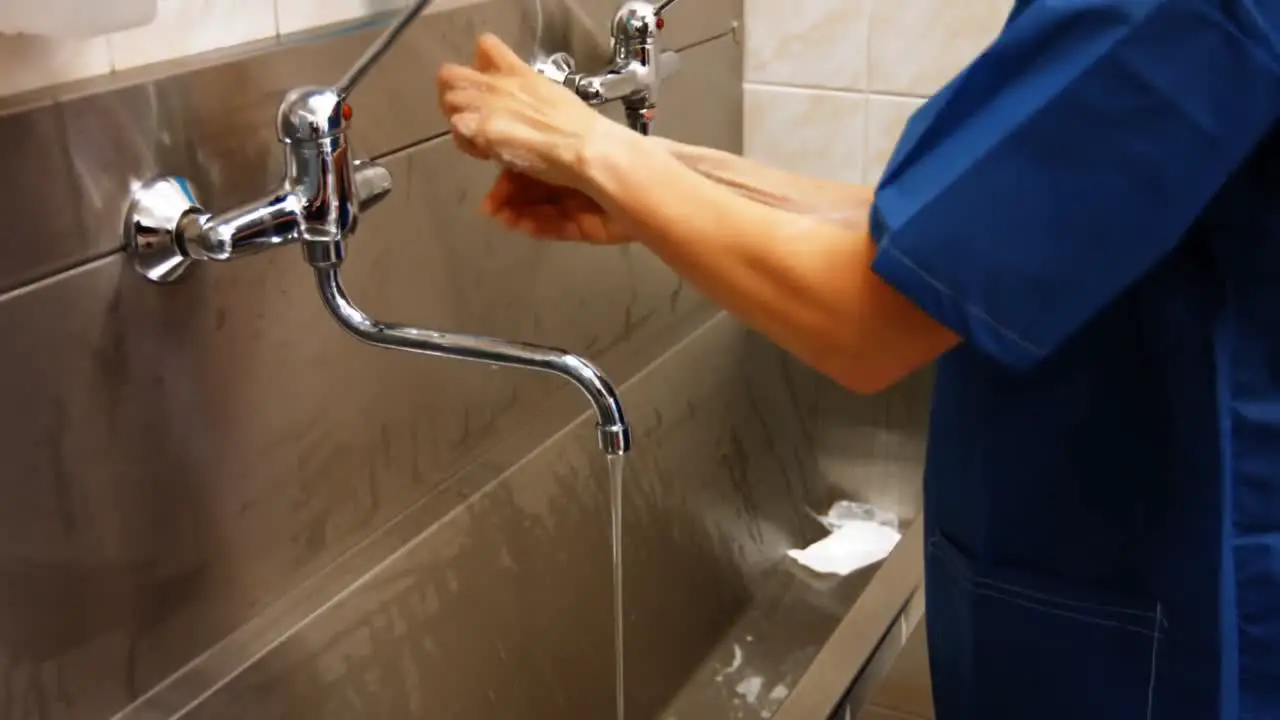 Surgeon washing hands with soap