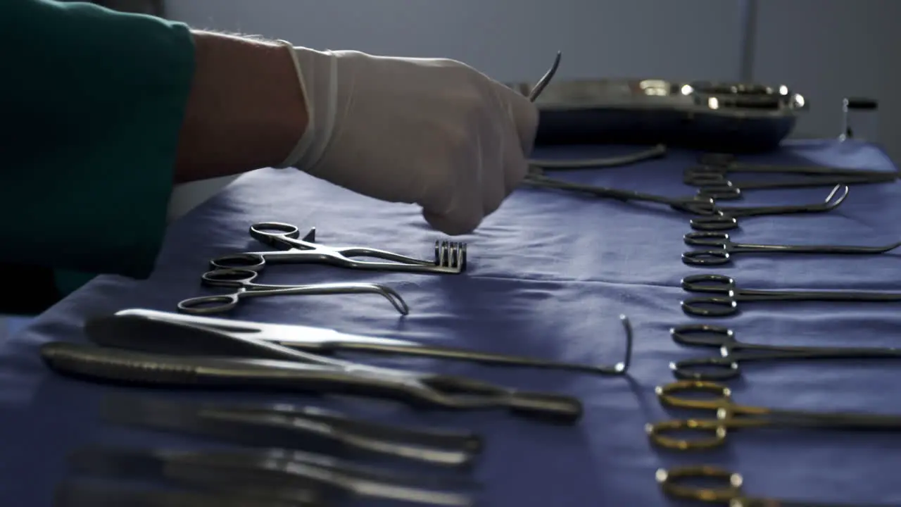 Close-up of surgeon arranging surgical tools on tray