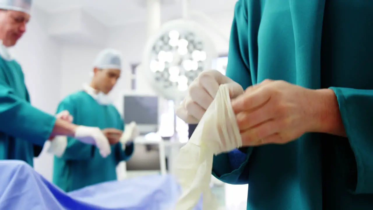 Surgeons wearing surgical glove