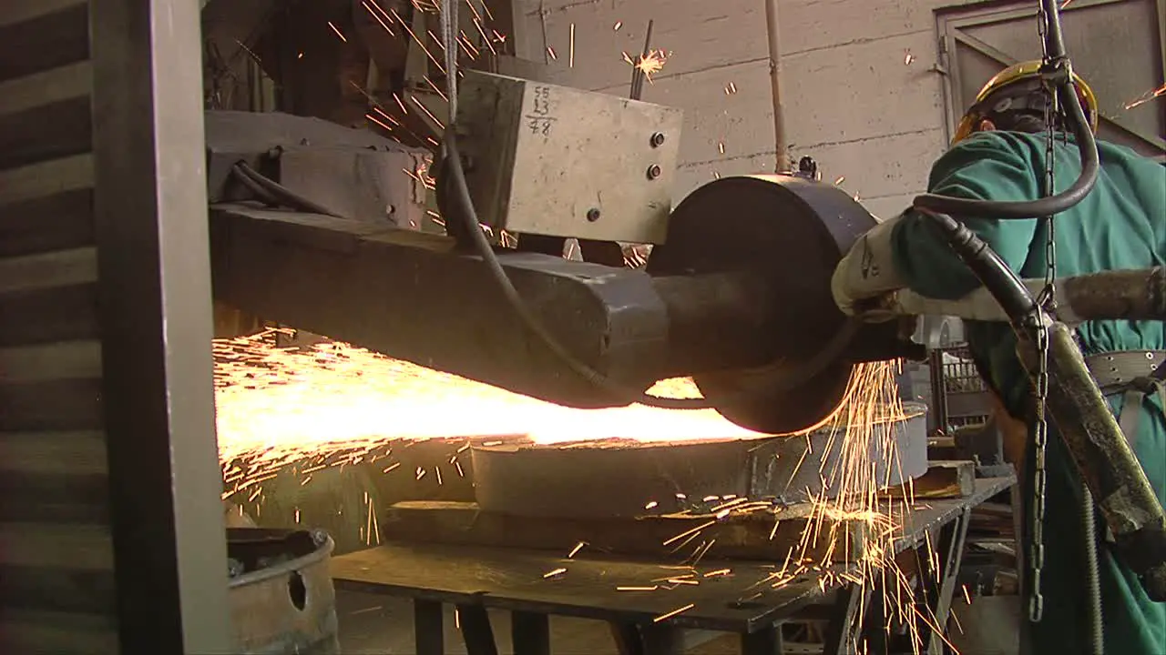 Worker Using Industrial Grinder