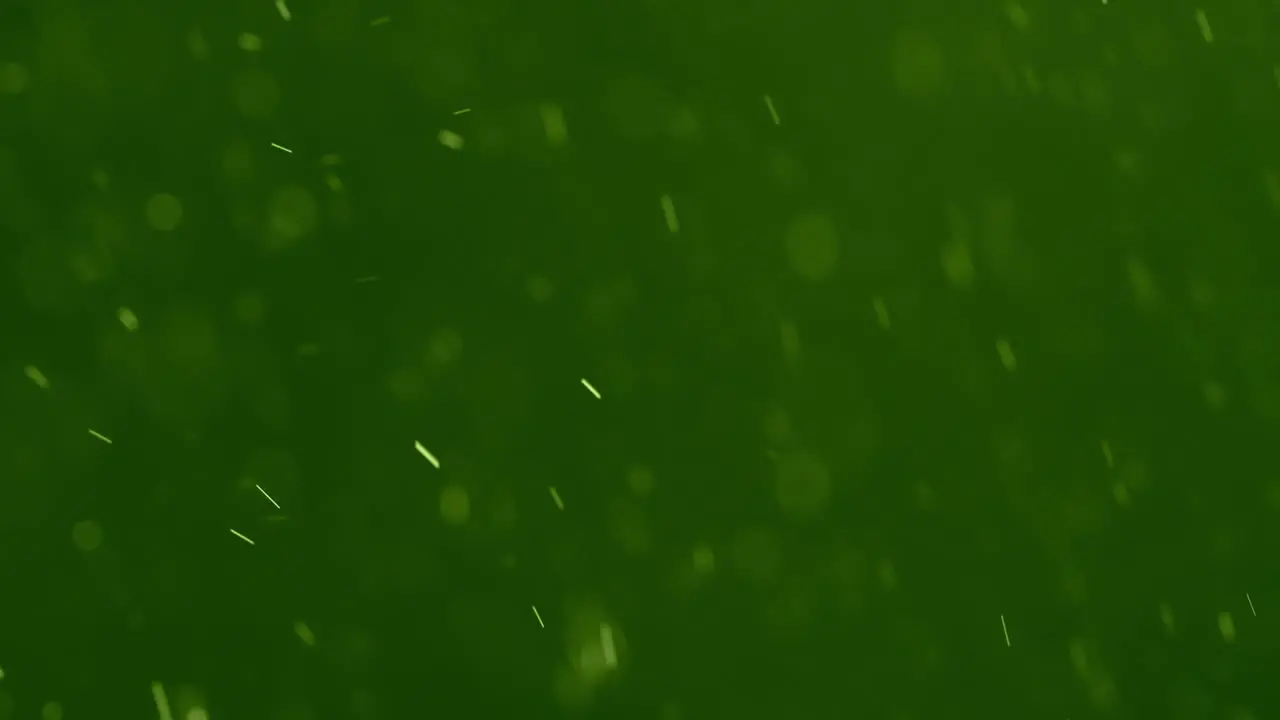 White Swirling Particles against a Green Background