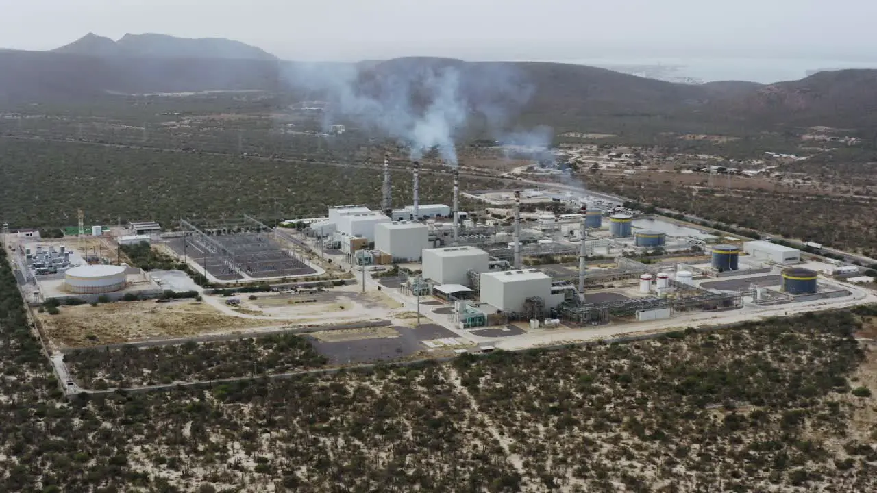 Aerial view of a power station emitting smoke in the middle of nowhere