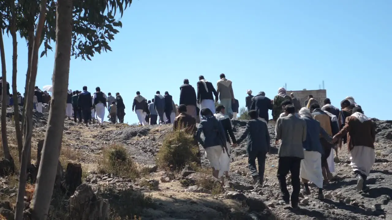 A lot of people walking to area of celebrating grooms