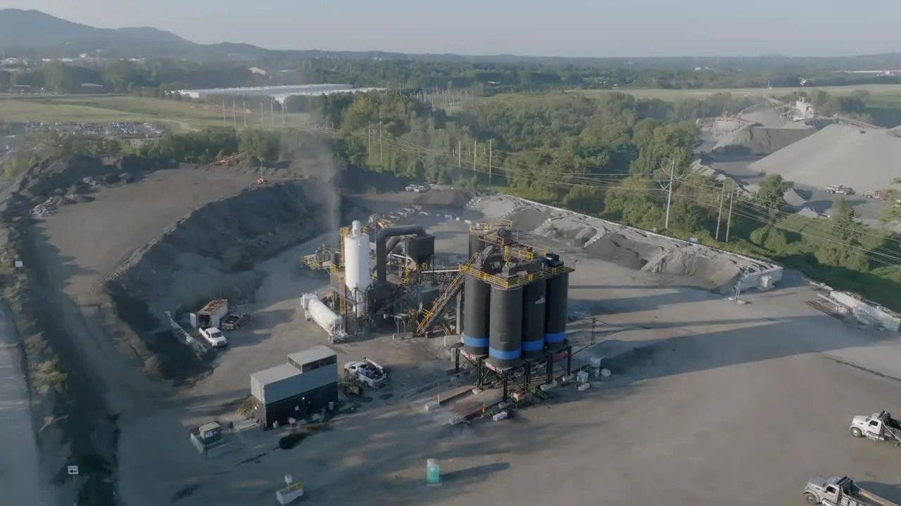 Static aerial footage of a industry site with smoke and oil containers