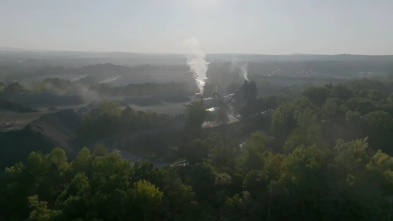 Wide aerial footage of a smokestack in the early morning in Kennesaw Georgia