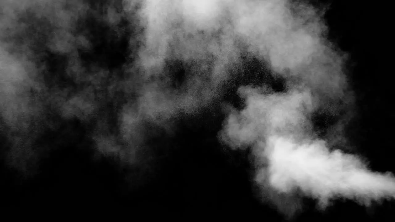 Clouds of dust erupt from screen right and drift up to screen left on black background