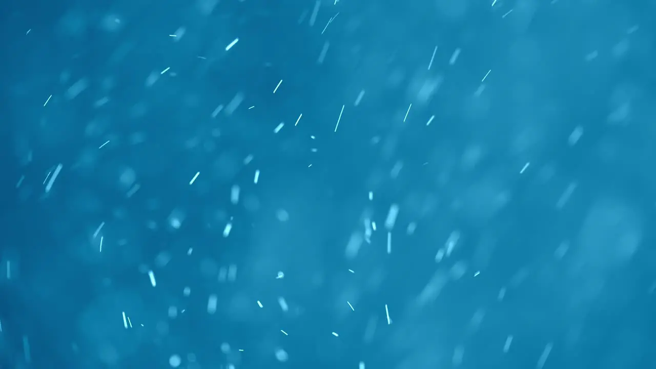 White Swirling Particles on a Blue Background