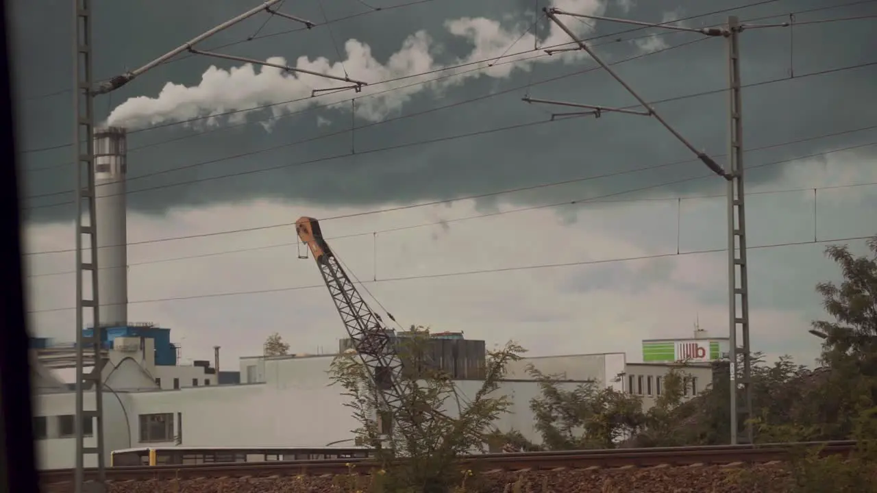 Smoke rising from the chimney of a factory as seen through a window pollution and climate change