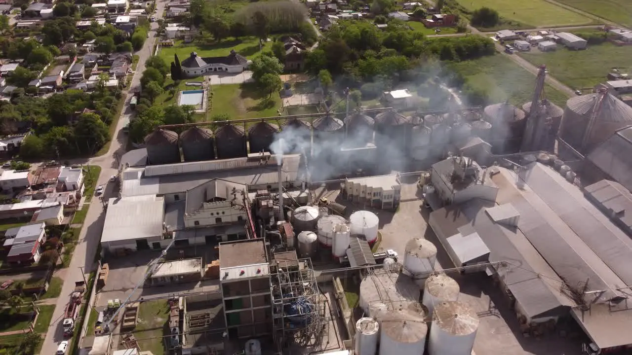 Drone flying over industrial chimney of food factory in Buenos Aires province Argentine