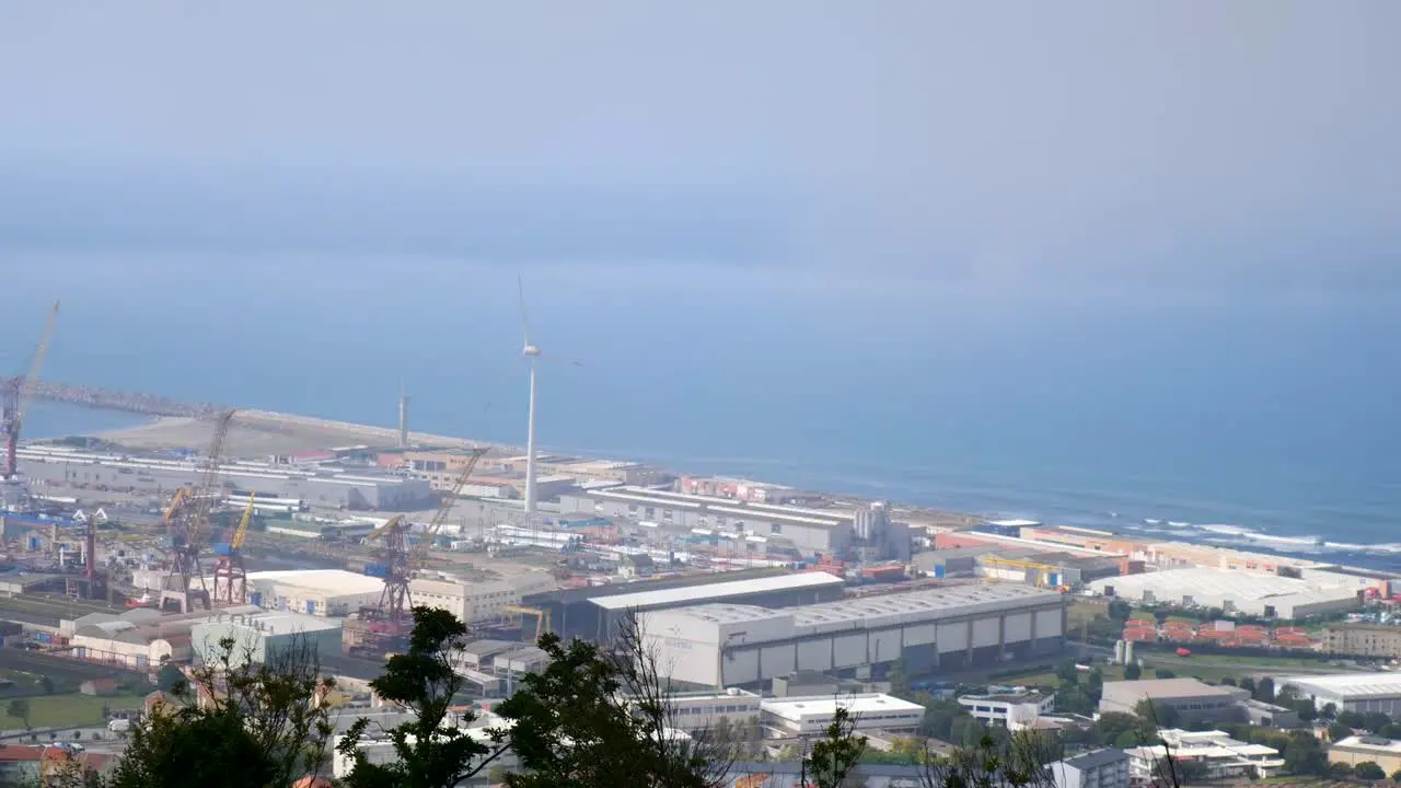 Industial harbor on the distance with energy generating wind turbines