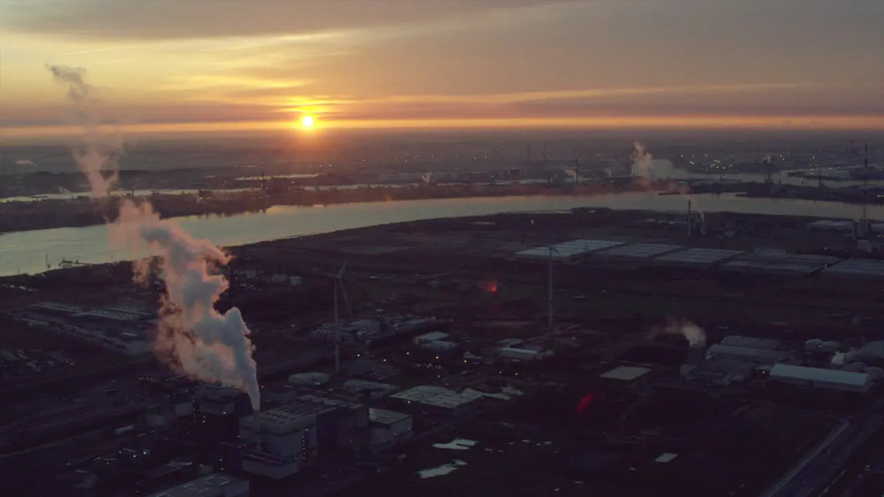 Industrial fumes on a port at sunrise