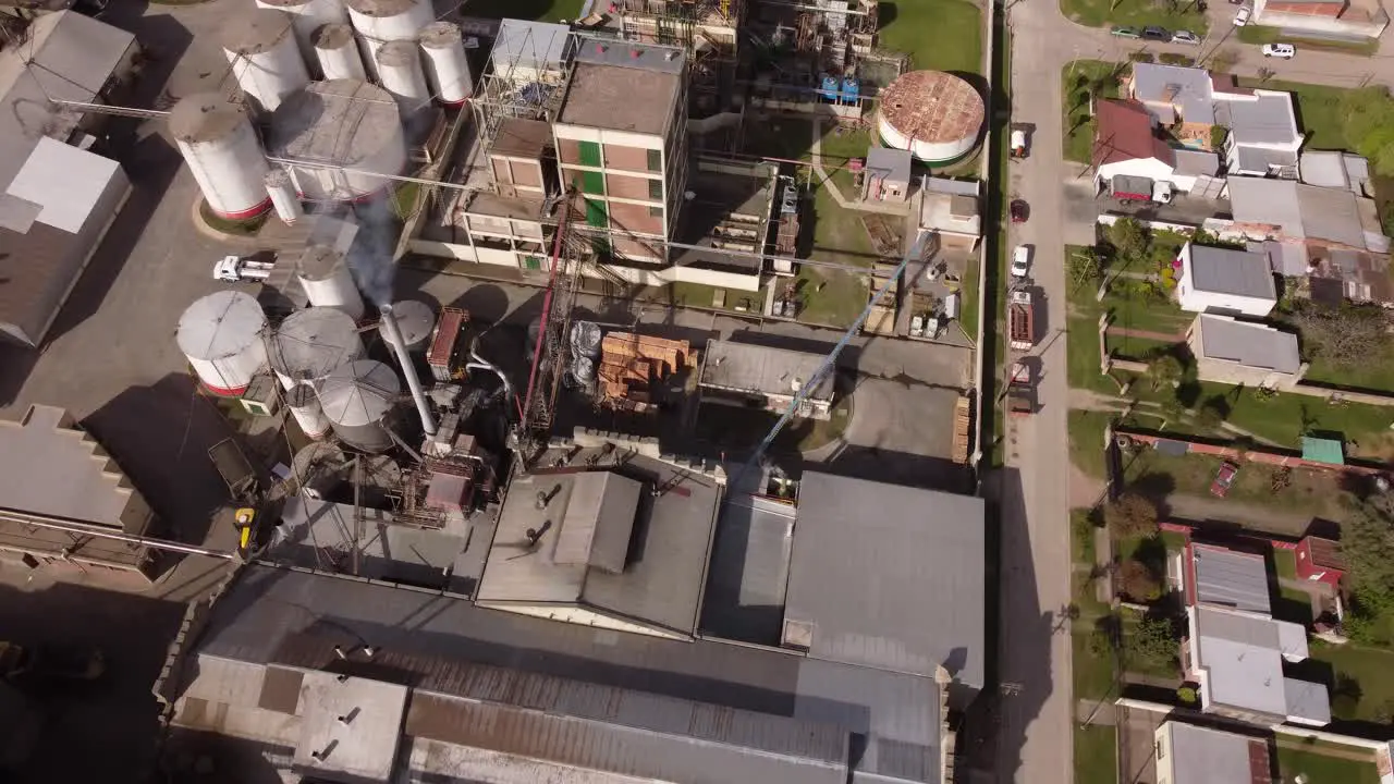 Aerial top-down orbiting over industrial chimney of food factory in Buenos Aires province Argentine