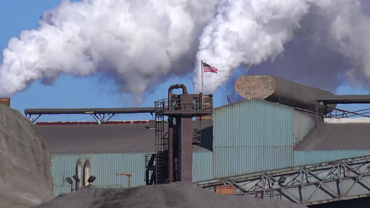 Global warming is suggested by shots of a steel mill belching smoke into the air 2