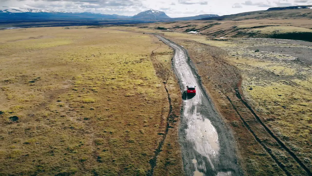 Red Car Driving Through Iceland