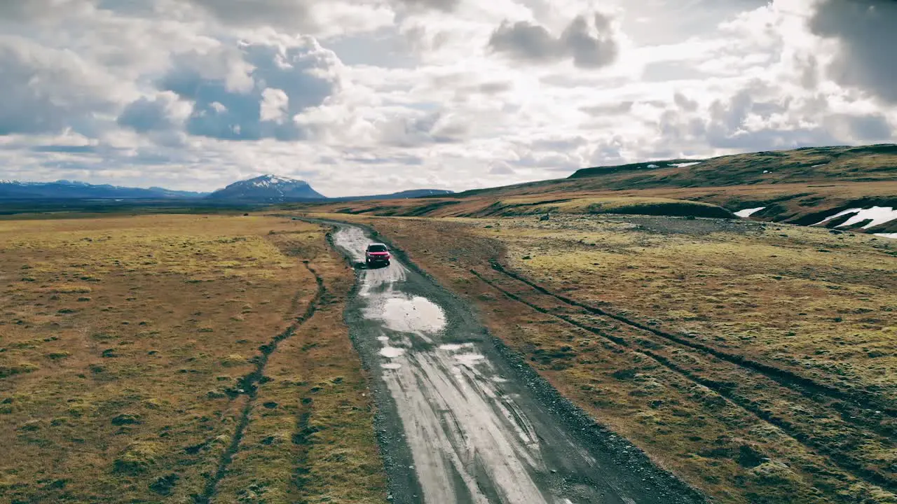 Red Car on A Dirt Road