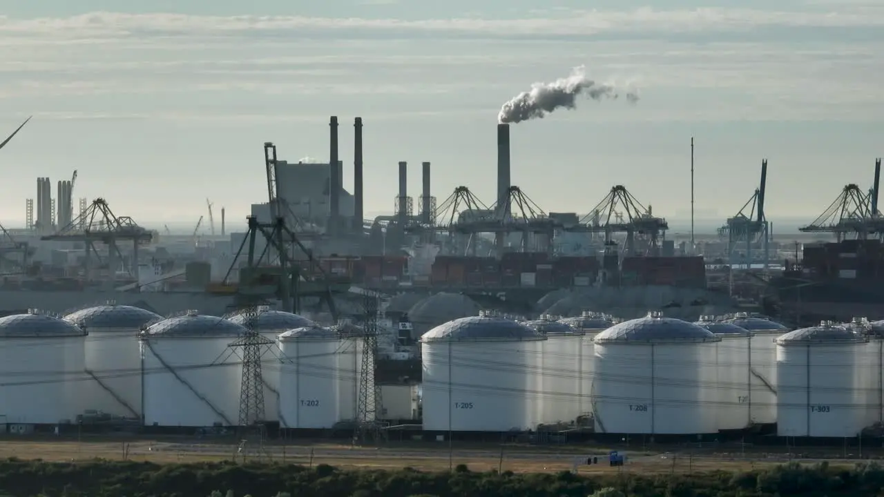 Smoke being released from industrial pipes at the busy port of Rotterdam Netherlands